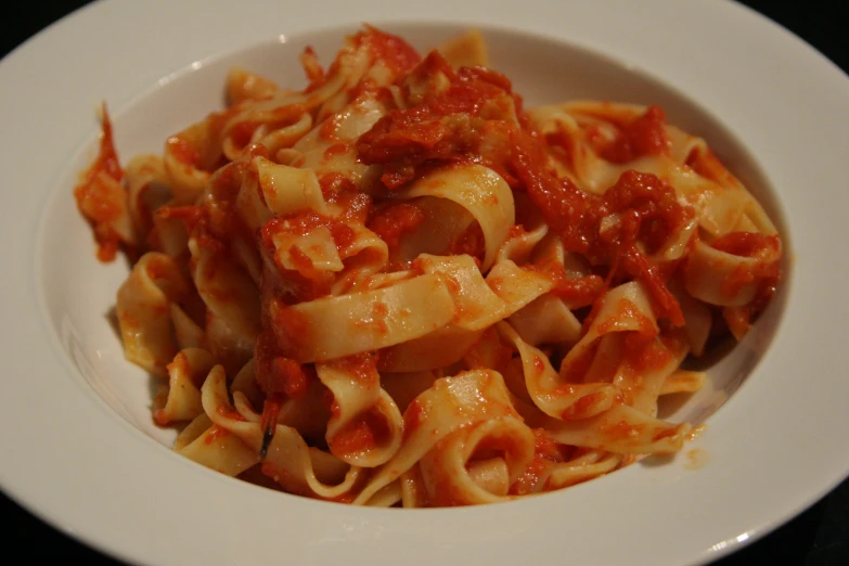 a white plate topped with pasta and sauce