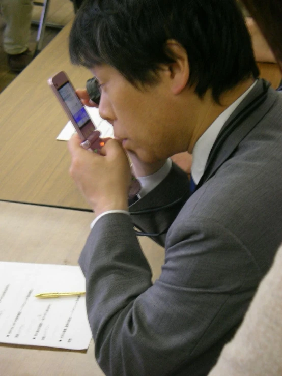 a man using a cell phone next to his ear