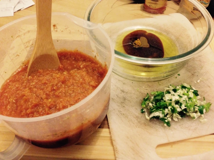 a plastic container filled with some sauce and garnished food