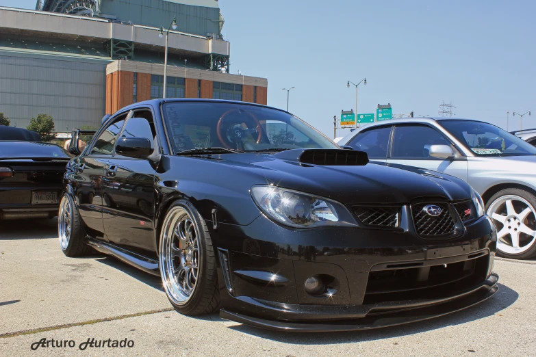 a nissan black sports car with chrome rims