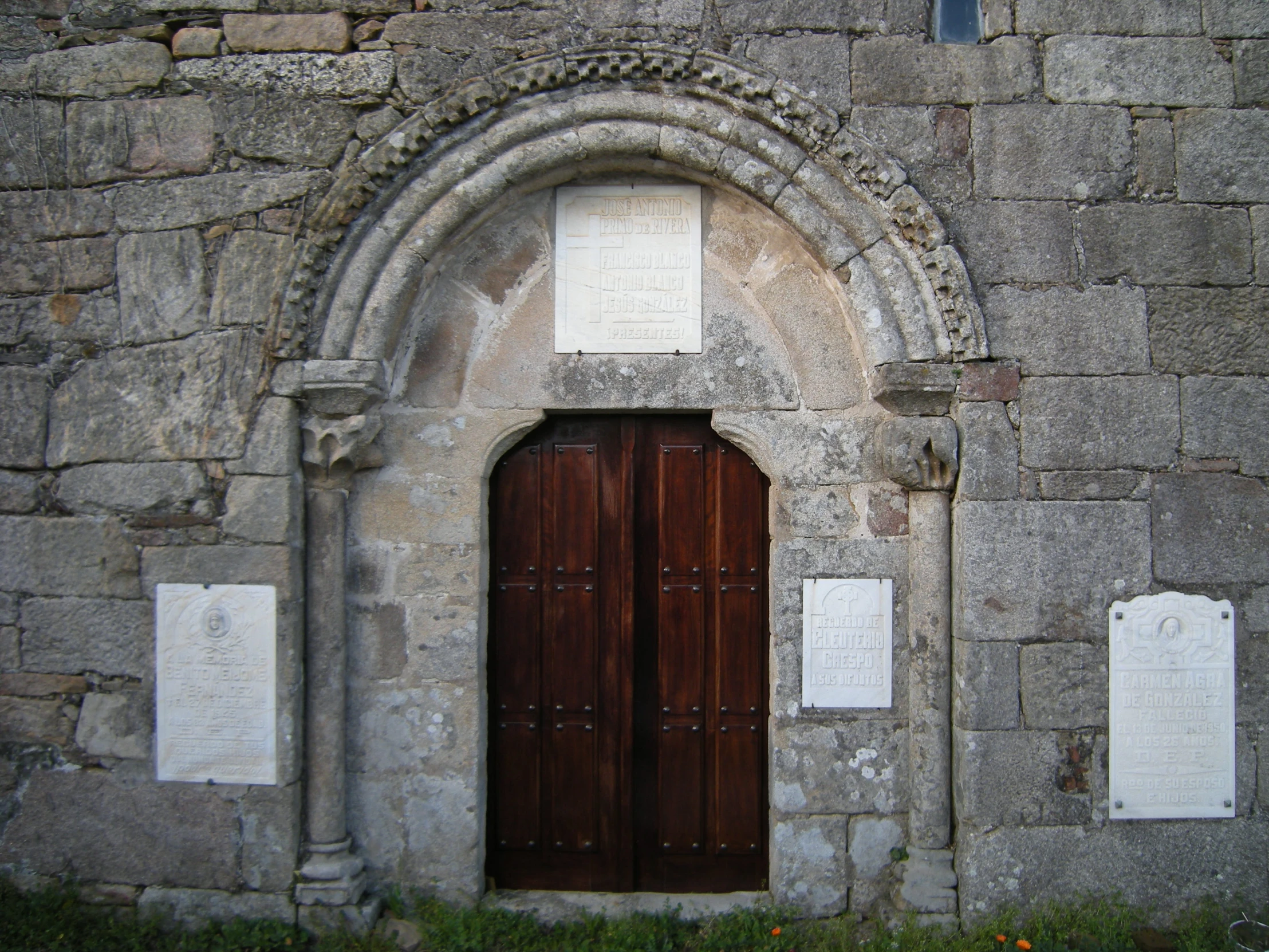 two doors are shown at the top of an old building
