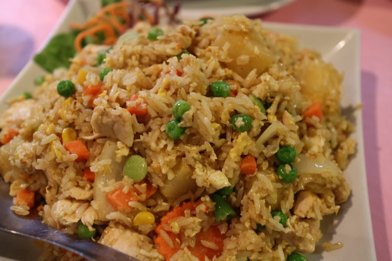 a plate with rice and veggies on it