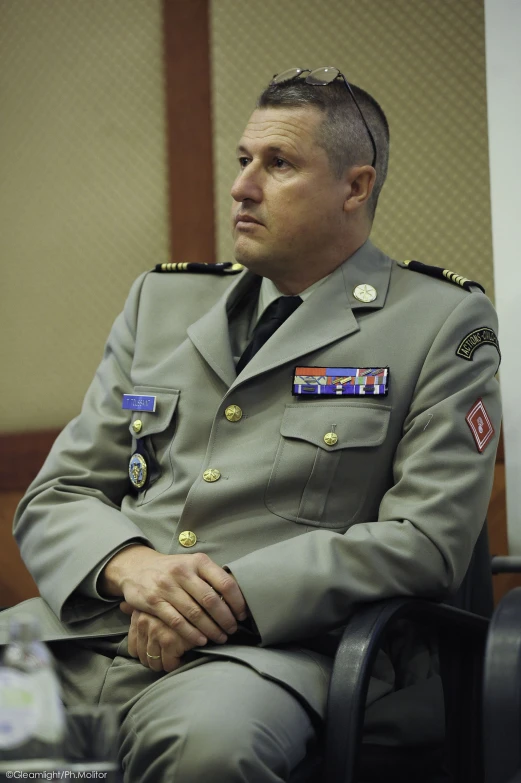 an image of a man in military clothes sitting down