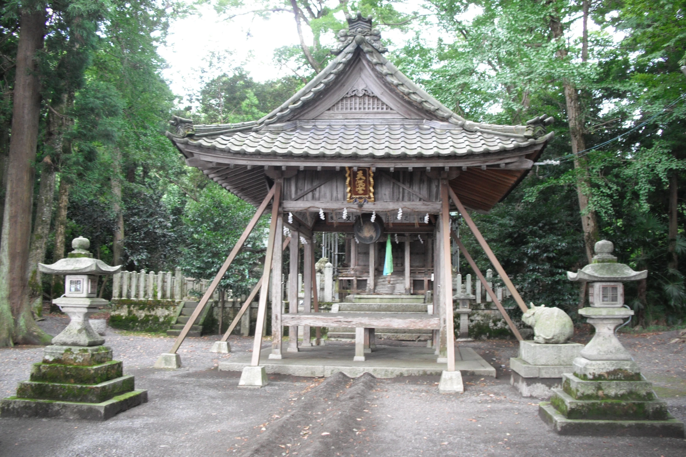 a pagoda shaped wooden building surrounded by trees