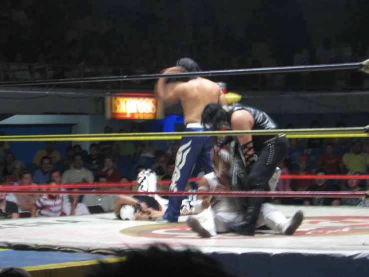 wrestlers and referee in a ring during a competition