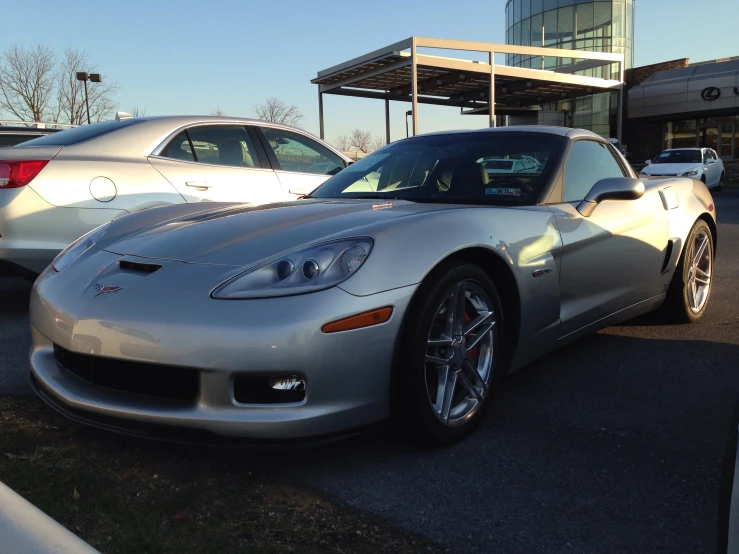 a silver corvette sports car is parked on the street