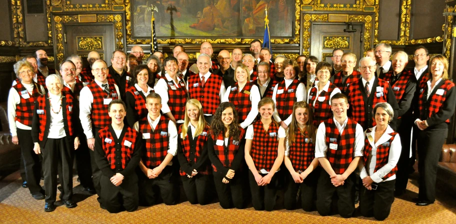 a group of men and women dressed in red and black plaid