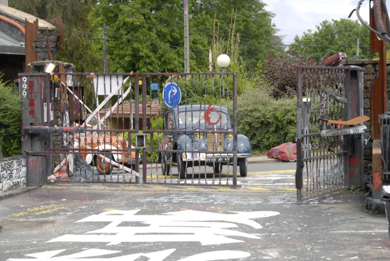 a lot of metal and wooden fences surrounding a street