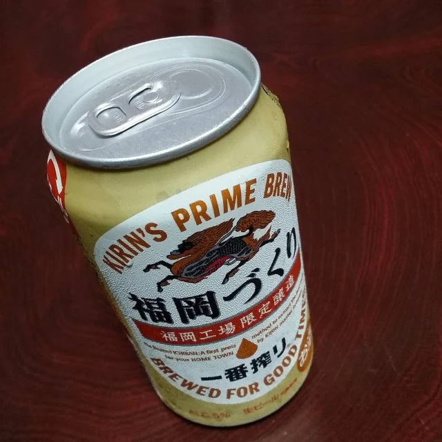 an asian canned drink with yellow mustard and a white cap