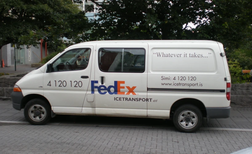 a fedex van parked in front of a building