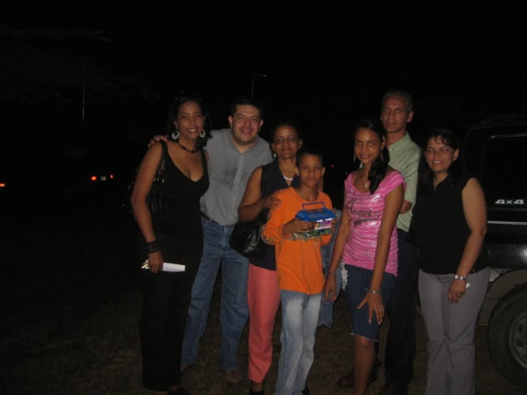 several people are posing in front of a truck