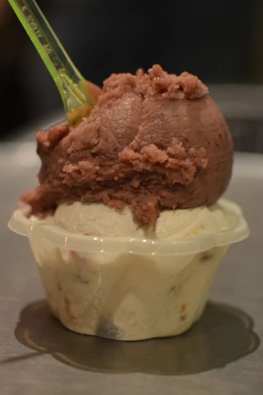 a plastic container containing a cup with ice cream