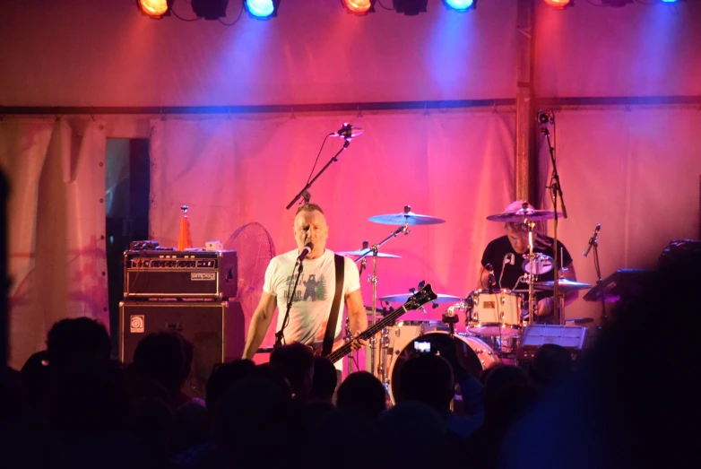 a man on stage playing a band set up