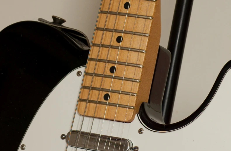 an electric guitar hanging upside down with a speaker