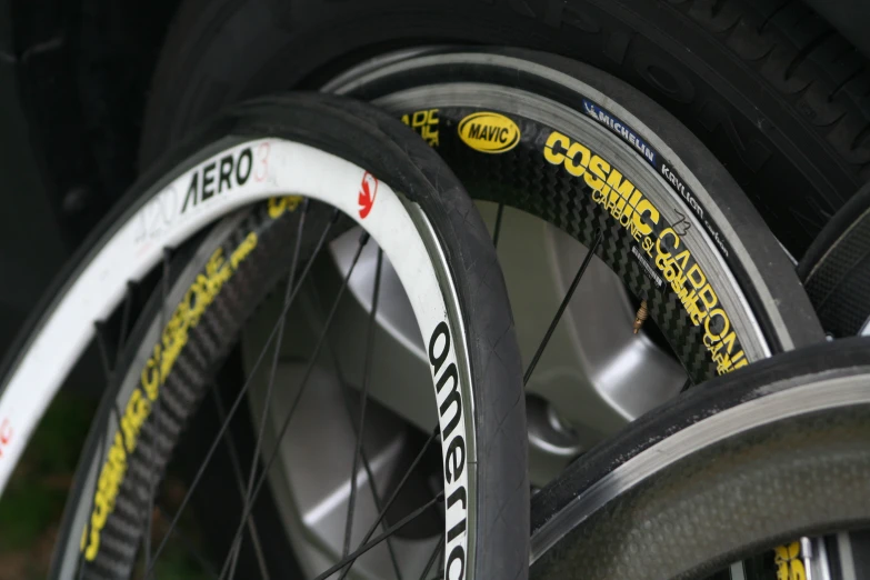 some black yellow and white bicycle tires are lined up