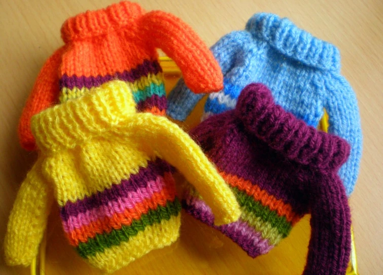 colorful knitted hats, on wooden surface