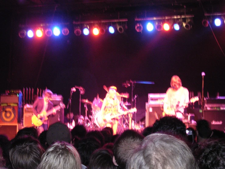 a group of people playing music on stage