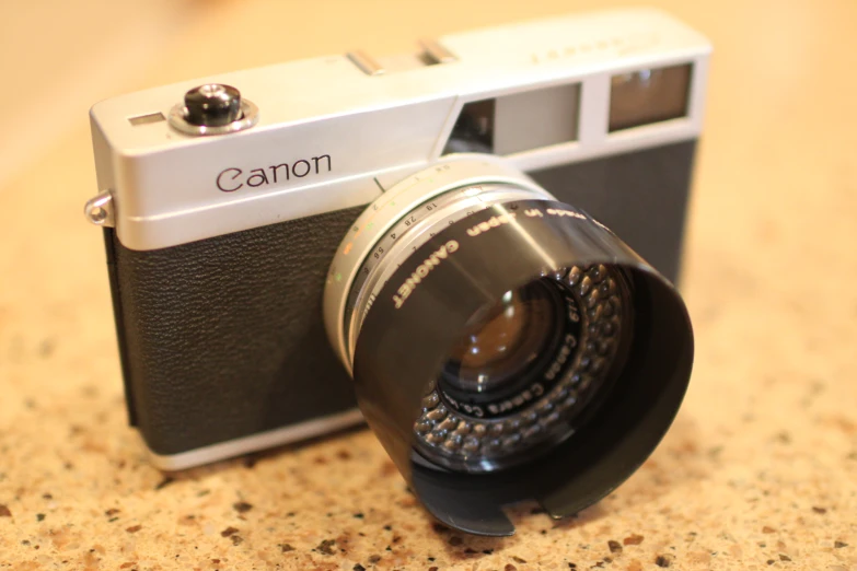 a camera with a lens pointed upward on a table