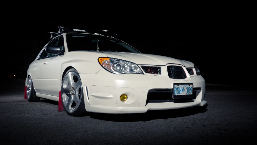 a white car with a light in the background