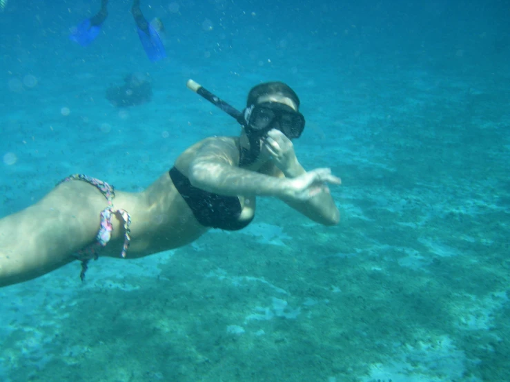 a woman wearing a mask and diving in the ocean