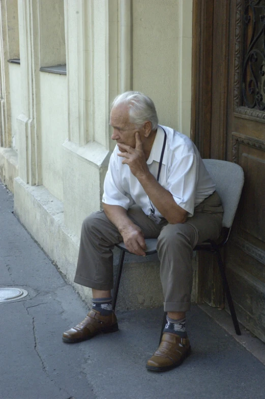 a man is sitting on a bench by the doorway