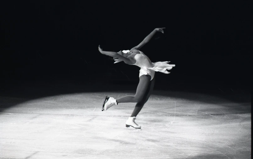 a woman in the air while performing on a stage