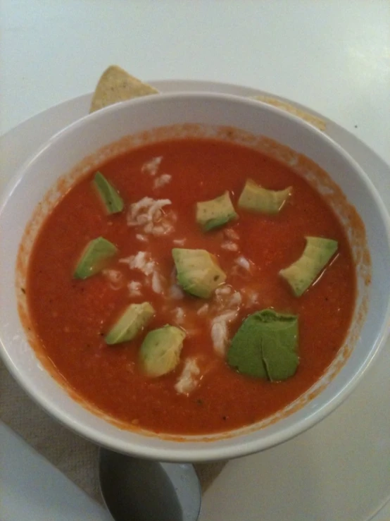 a bowl of soup with tortilla chips on top