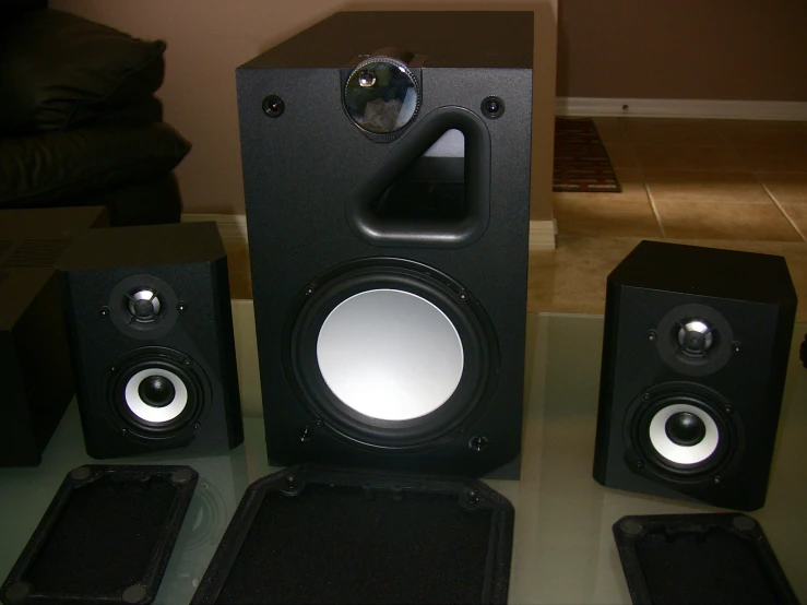 a speaker sitting next to two other speakers