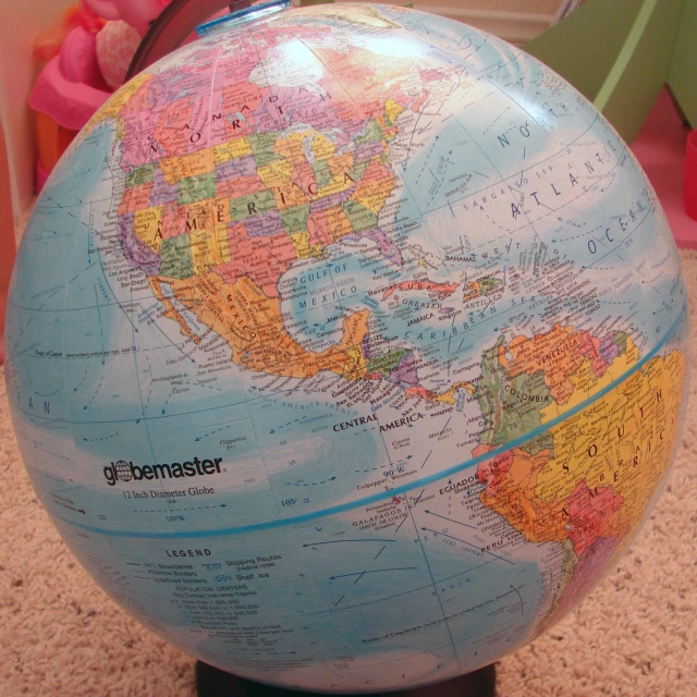a large globe sitting on a shelf in a child's room
