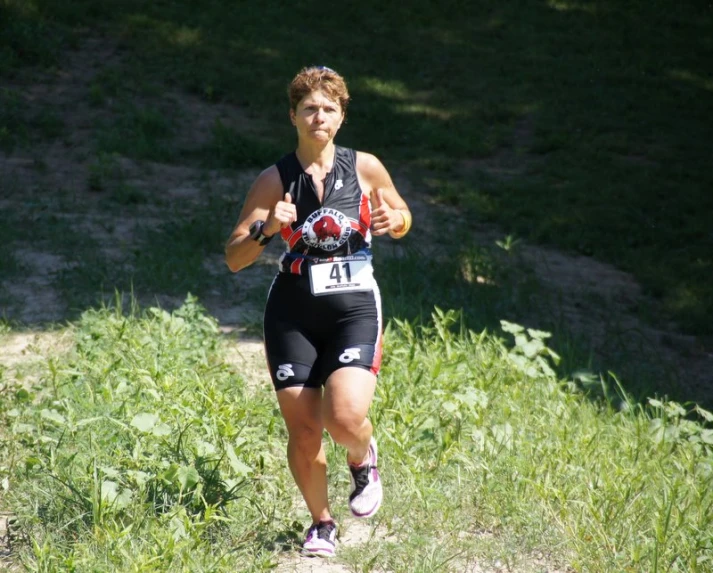 woman with sunglasses on running in a race