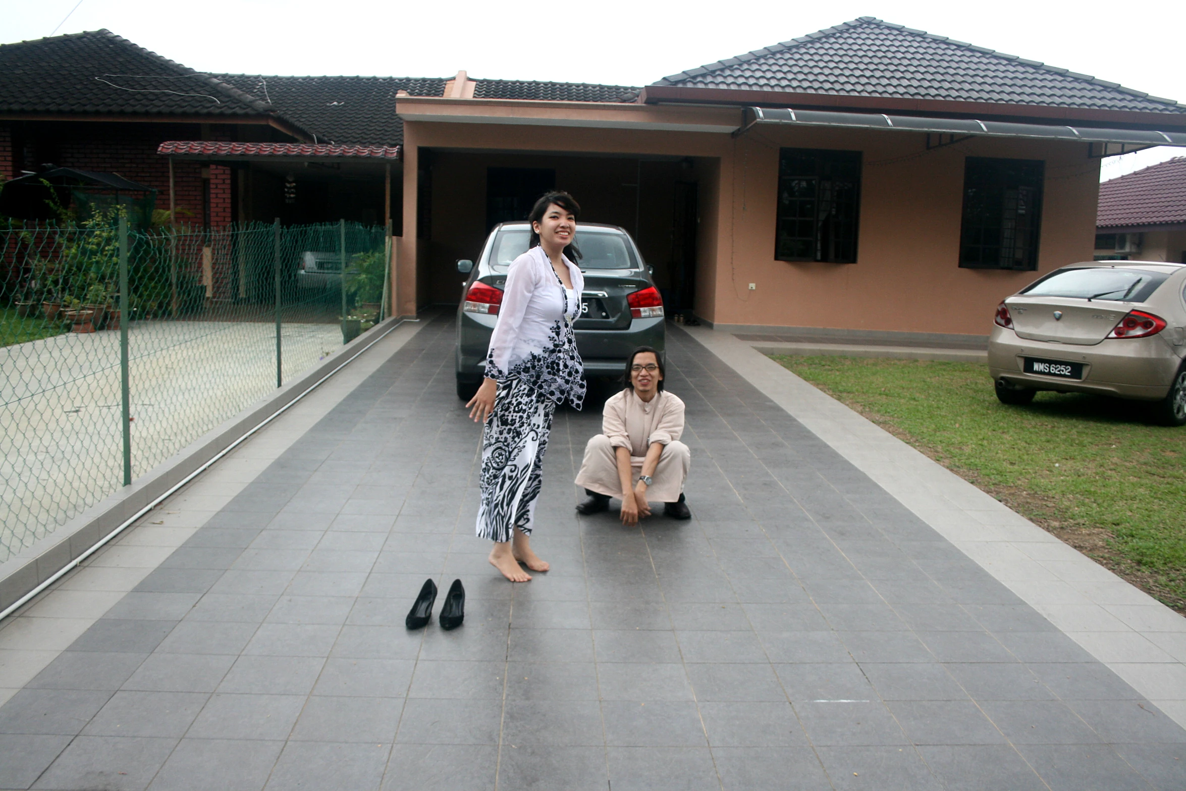 a woman sitting on the ground next to another woman