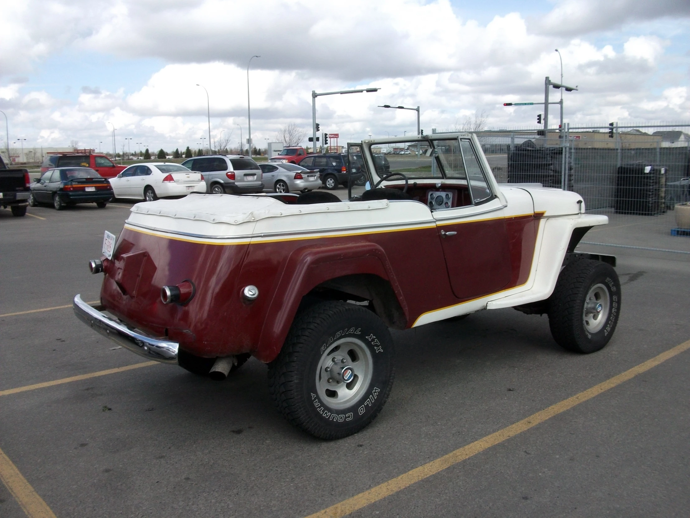 a red and white pick up truck in a parking lot