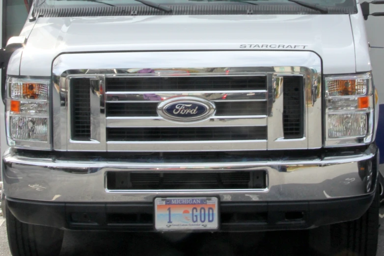 silver truck parked outside with the license plate