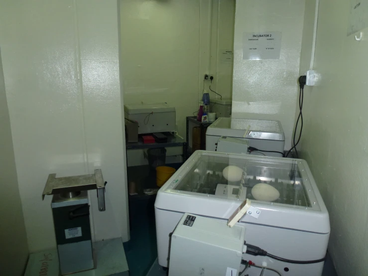 a small room containing many machines with wires and equipment inside