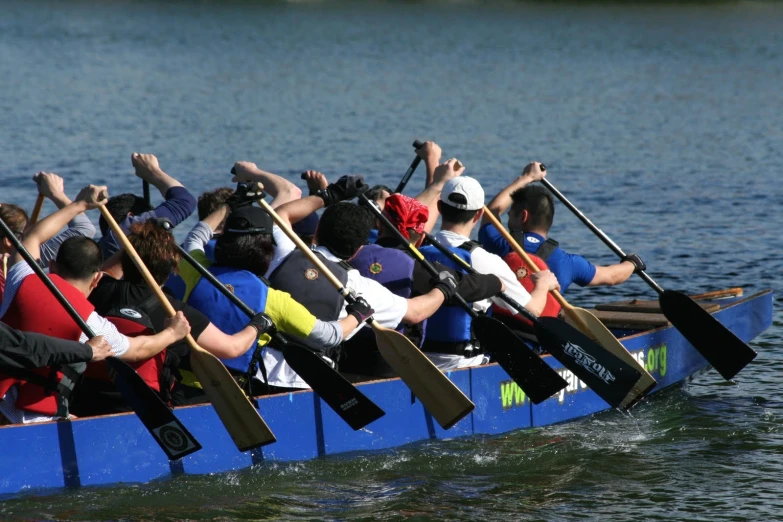 people in a canoe with their hands on the water