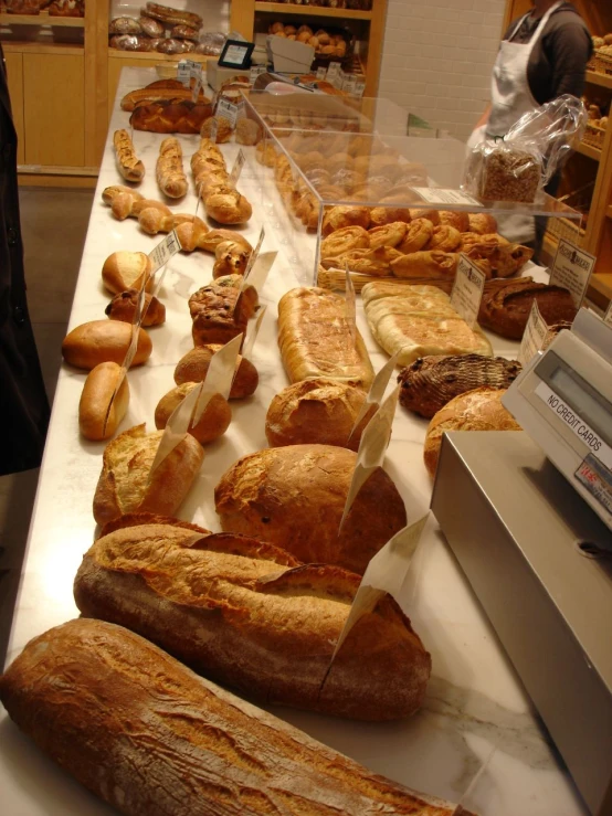 an assortment of breads sitting on the counter