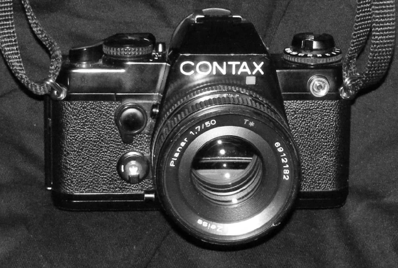 black and white pograph of a camera with the text contax on it