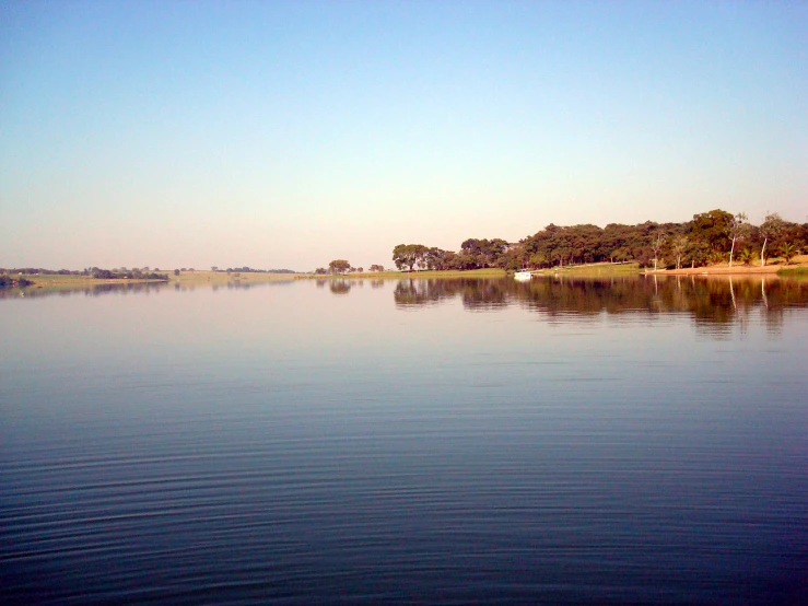 an image of water that is still blue in the day