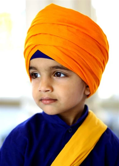 a  in blue shirt and orange turban