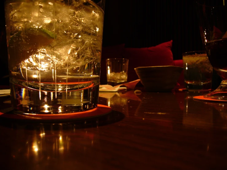 glass filled with ice sitting on a table