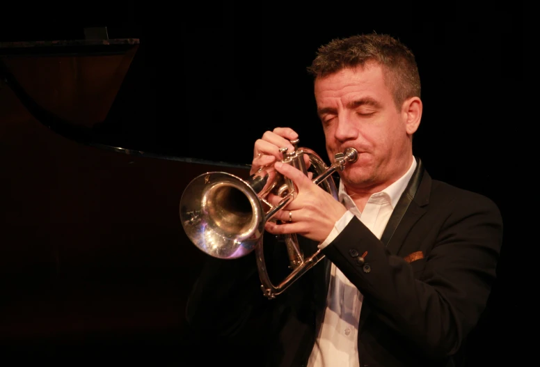 man playing the trumpet at an event