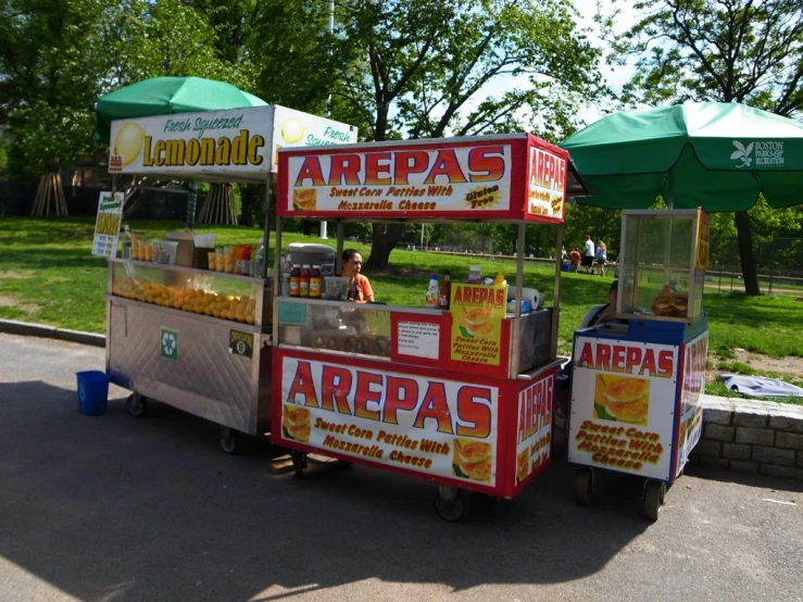 an outdoor concession stand selling various types of food