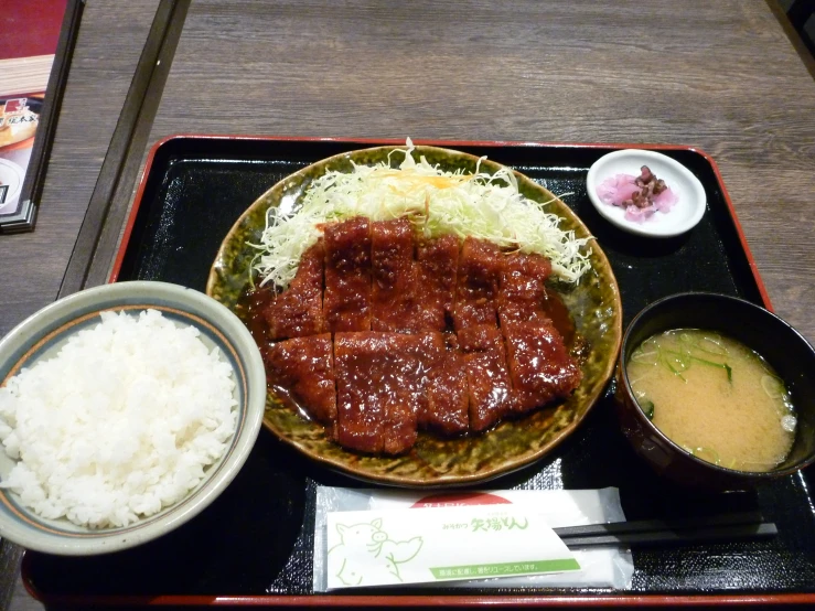 the meat is served on the plate with rice
