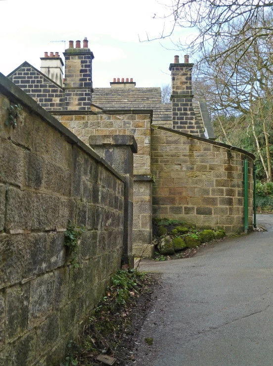 a walkway between two old stone buildings