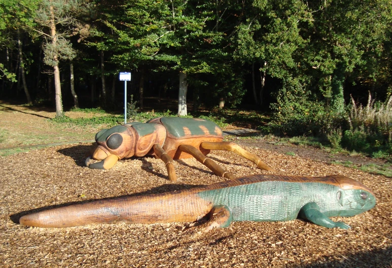 two large sculptures of bugs next to each other