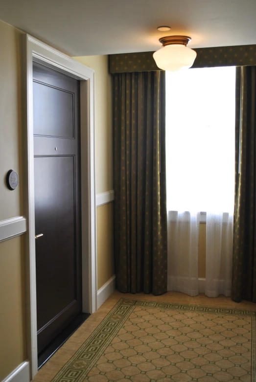 a living room with a rug and a doorway