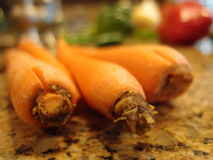 some carrots are on the table with some basil