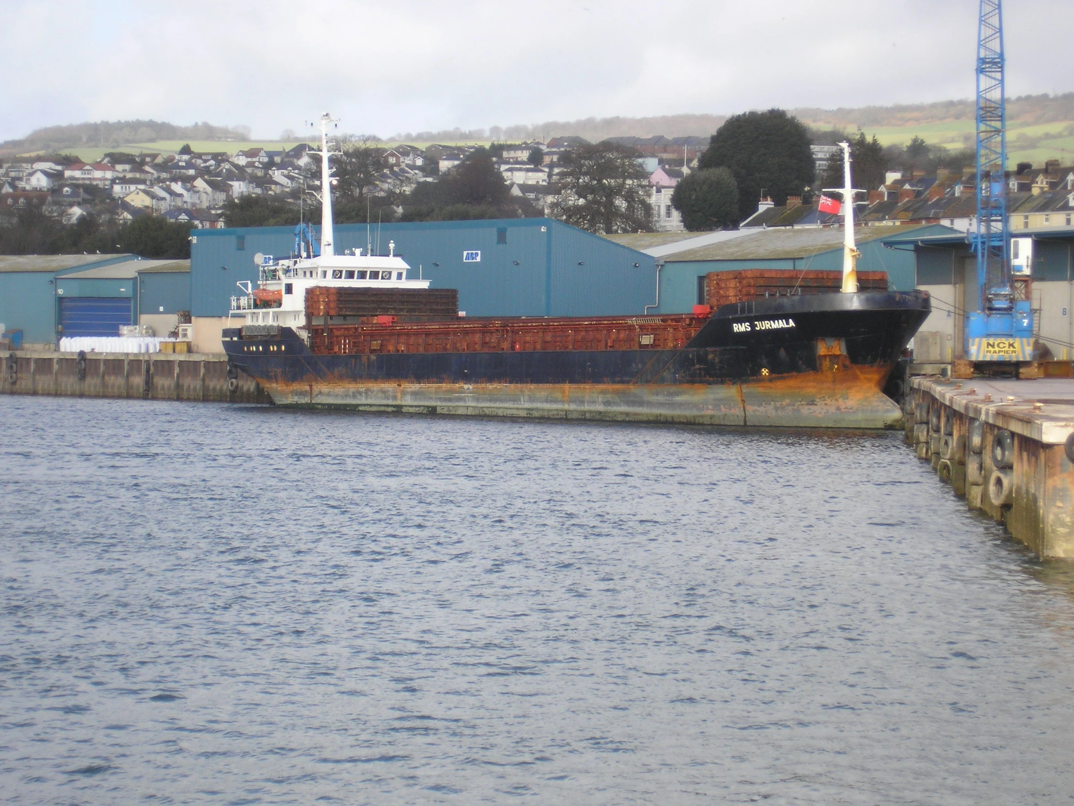 a ship sitting on a body of water in a harbor