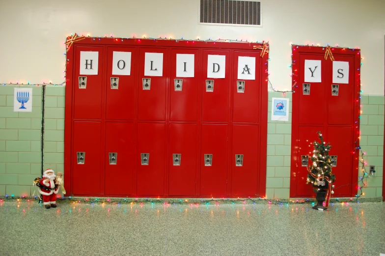 the lockers are all red and there is a small child beside them