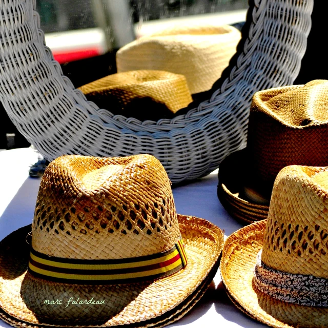 a group of hats sit on a white table